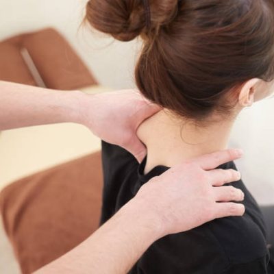 A Japanese woman getting a shoulder massage at a seitai clinic